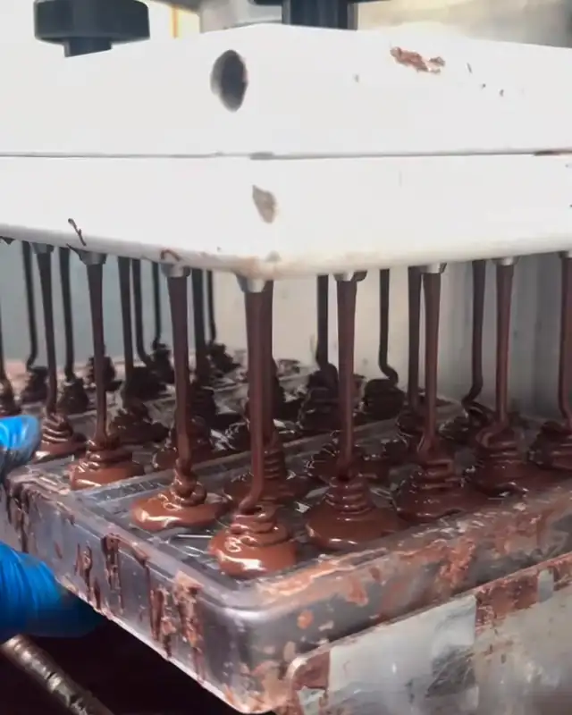 Chocolate being deposited into molds